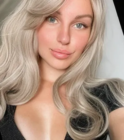 Blonde OnlyMonster creator with green eyes taking a selfie